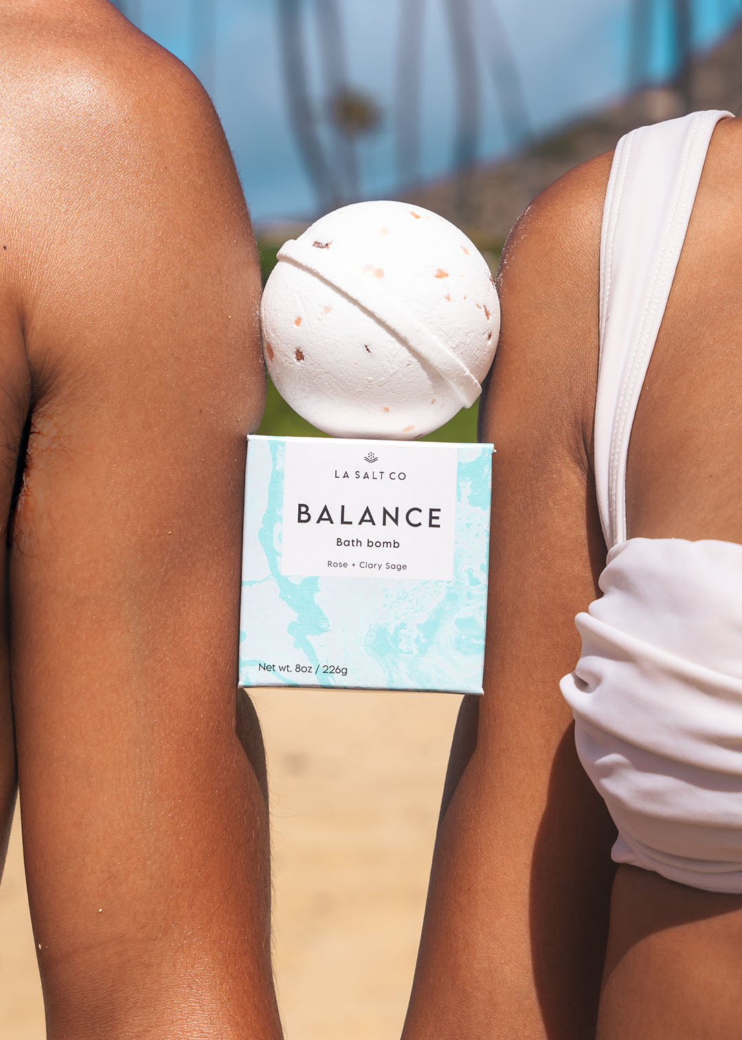 A Balance Bath Bomb wedged between a man and a woman