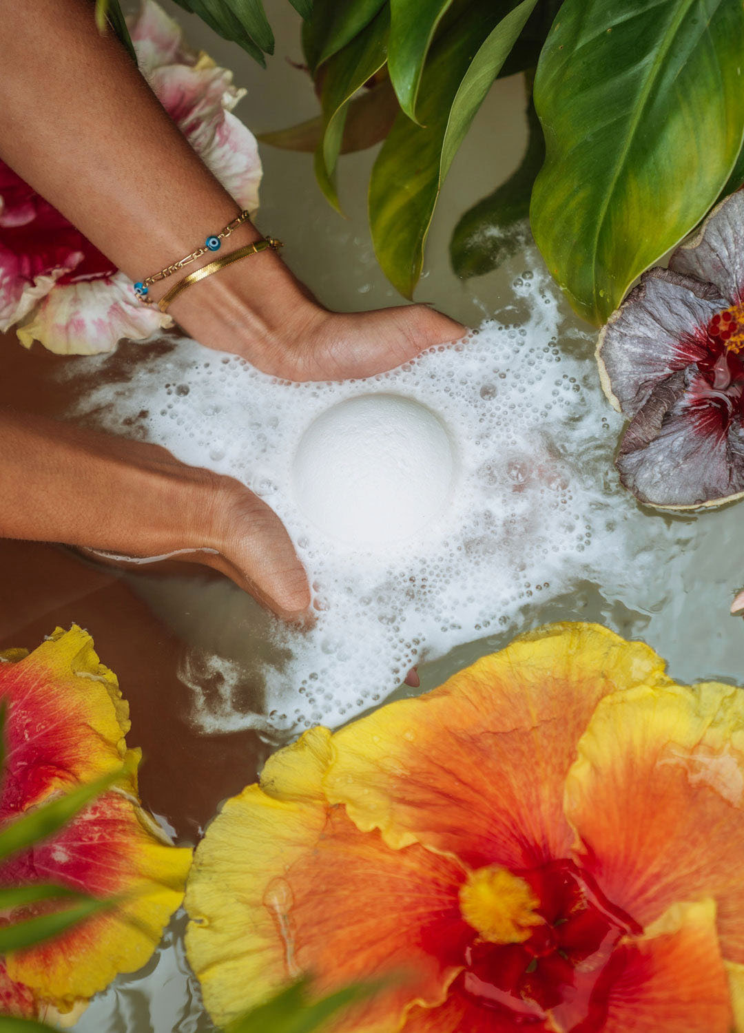 A Joy Bath Bomb fizzing in a floral bath